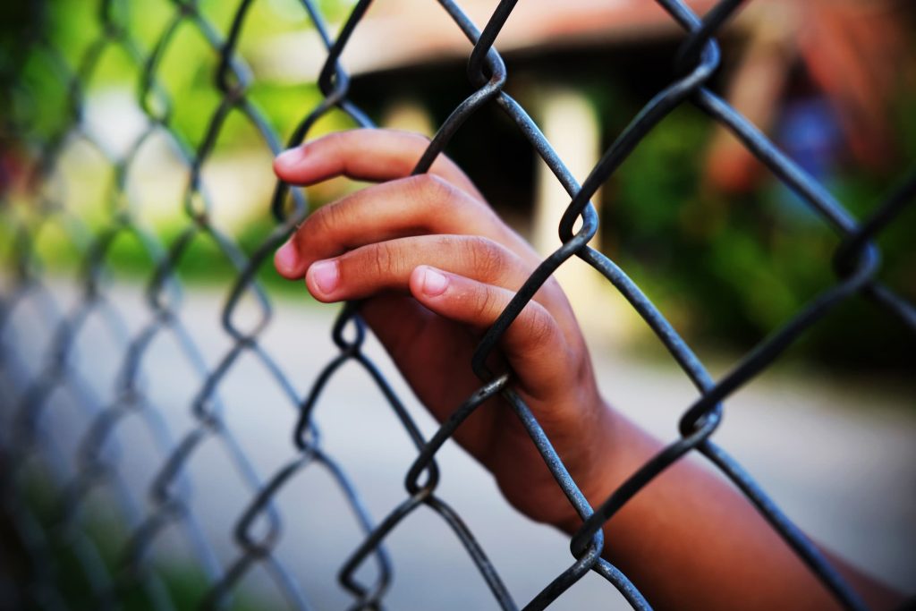 Juvenile hall lawyers hand and fence